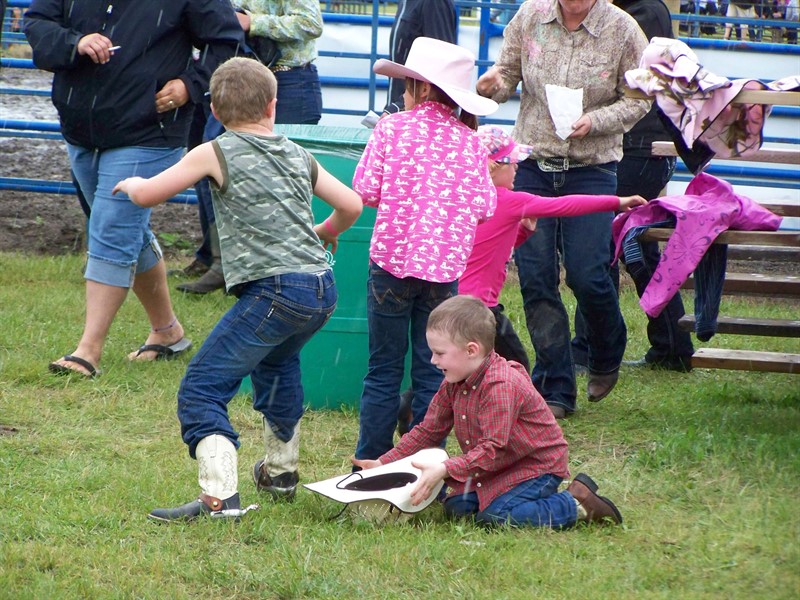 Children playing in the graas at the Rodeo