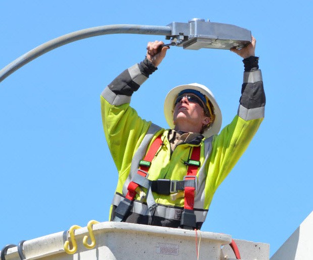 Worker repairing street light